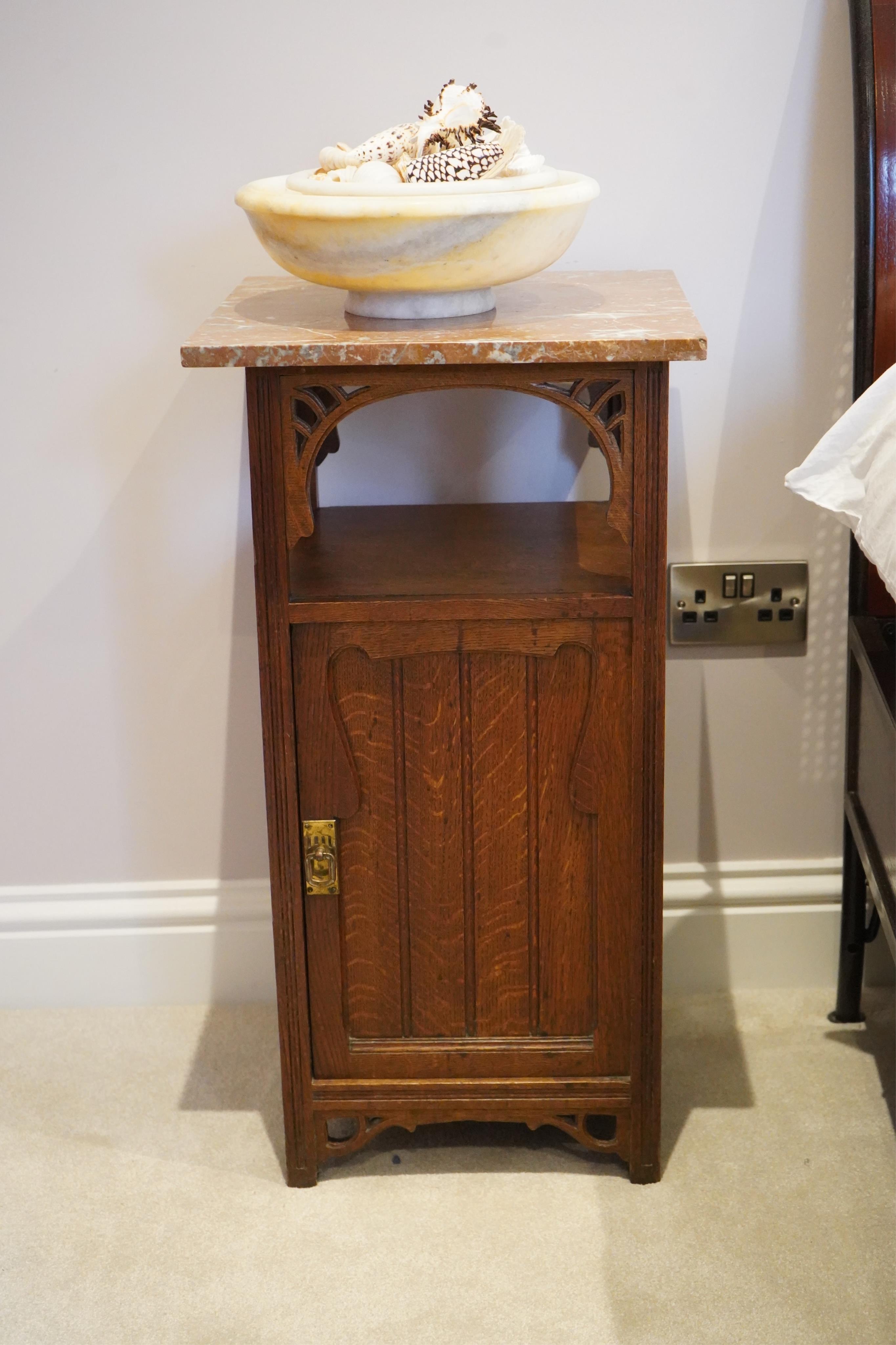 A pair of French Art Nouveau oak marble topped bedside cupboards, width 42cm, depth 42cm, height 81cm. Condition - fair